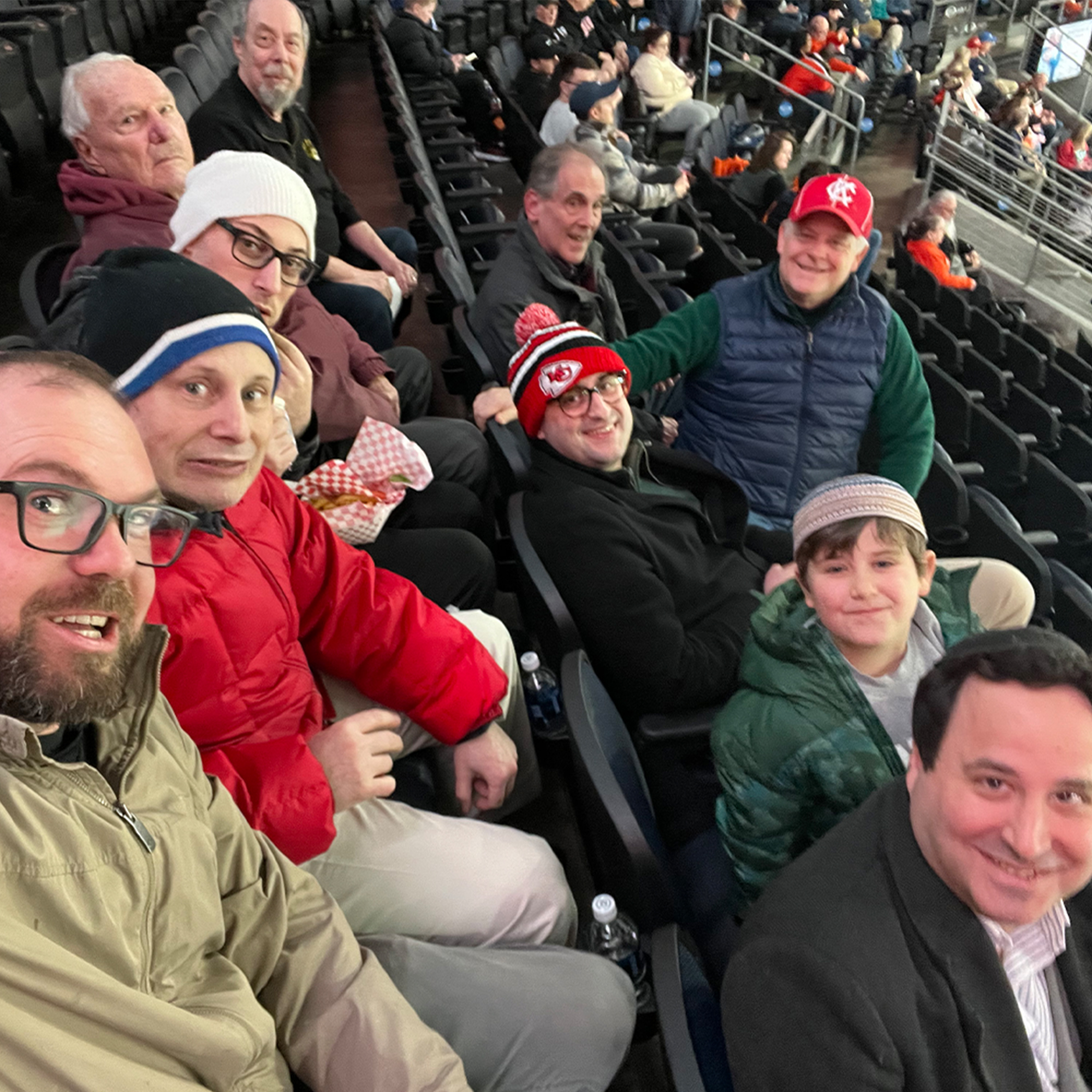 Group_of_men__sitting_in__stadium